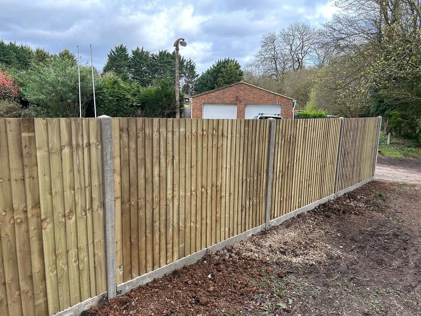 Finished fencing installation surrounding landscaped garden